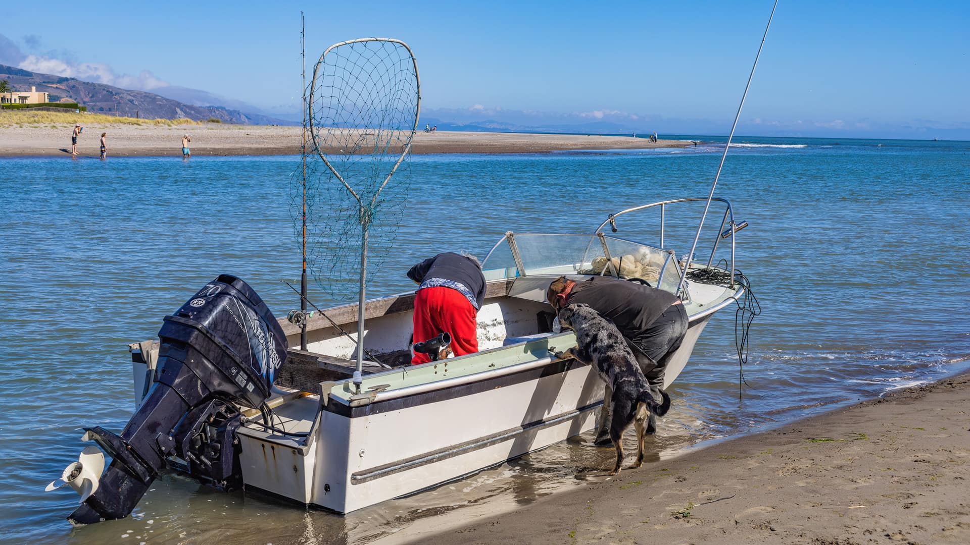 Tohatsu outboard motor on a fishing boat launching from the beach