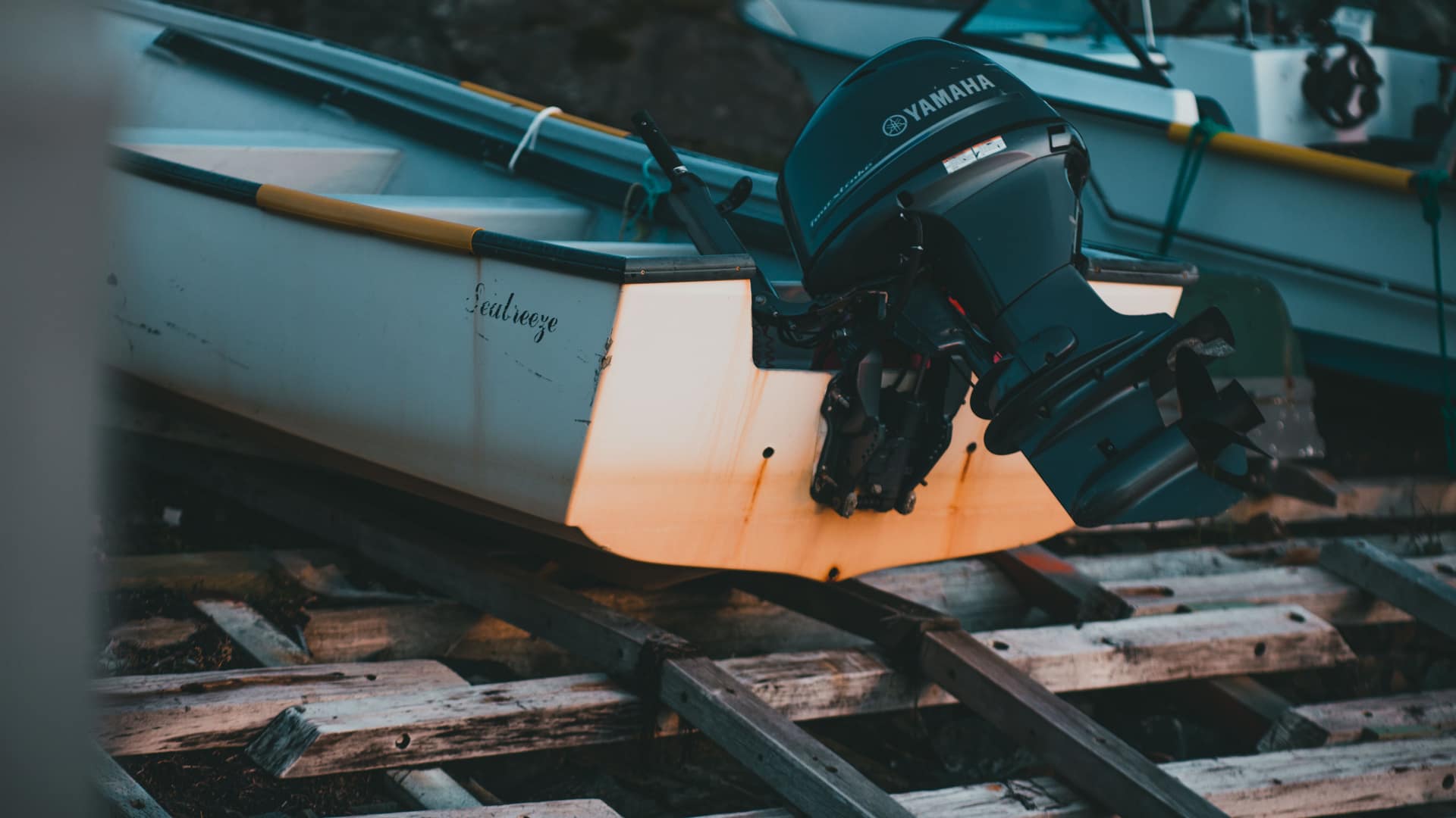Yamaha outboard motor mounted on a boat in dry dock at sunset